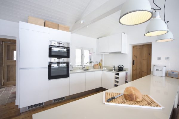 Modern contemporary kitchen in open plan living room with vaulted ceiling